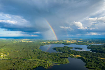 Aerial summer beautiful view of rainbow over the forest and lake, lithuania