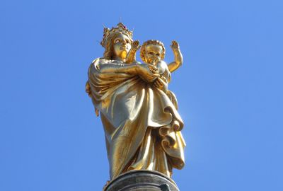 Low angle view of virgin mary and jesus christ sculptures on top of notre dame de la garde