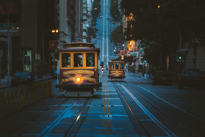 View of illuminated cable car on street