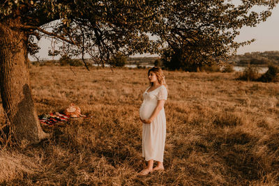 Side view of woman standing on field