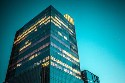 Low angle view of modern building against clear blue sky