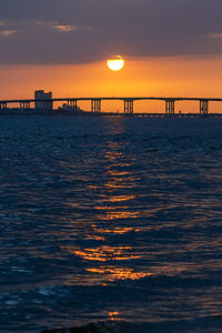The sun sets on the biloxi-ocean springs bridge