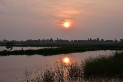 Scenic view of lake against sky during sunset