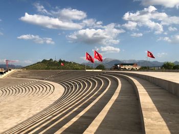 Red flag in stadium against sky