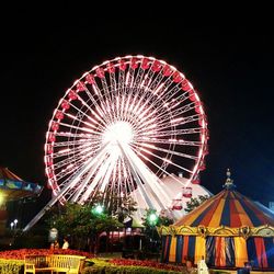 Low angle view of illuminated ferris wheel