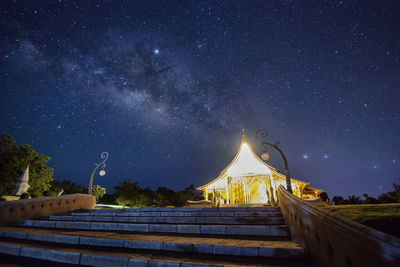 Low angle view of illuminated building against sky at night