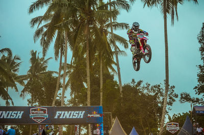 Low angle view of man riding sign against sky