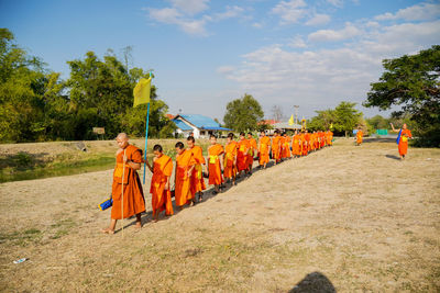 Panoramic view of people on street against sky