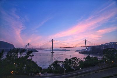 Suspension bridge over river at night