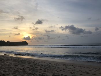 Scenic view of beach against sky during sunset