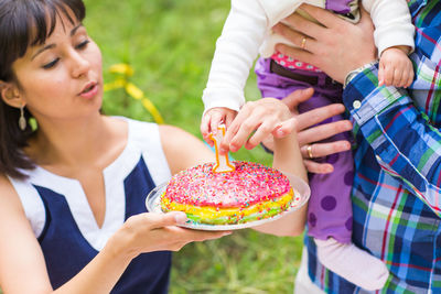 Midsection of woman holding cake