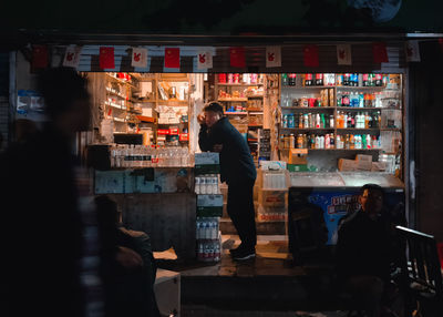 Rear view of people working at night