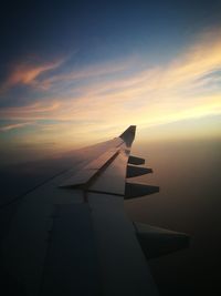 Cropped image of airplane flying over clouds