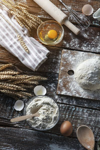 Rustic bread roll or french baguette, wheat and flour on black chalkboard. rural kitchen or bakery 