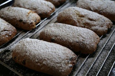 Close-up of pastry items with powdered sugar on baking sheet