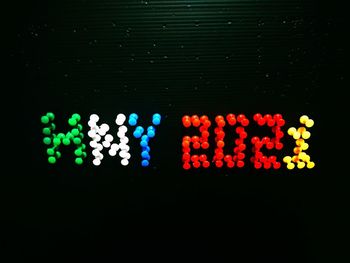 Close-up of illuminated lighting equipment on black background