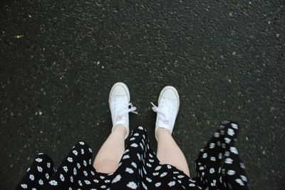 Low section of woman standing on street