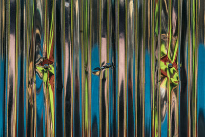 Full frame shot of abstract reflection on aluminum sheet fence