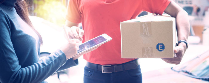 Close-up of hand holding smart phone outdoors