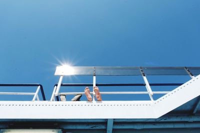 Low angle view of man against blue sky