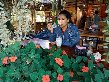 Woman holding flowers on plant