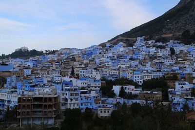 Buildings in town against sky