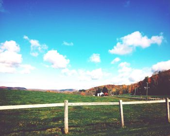 Scenic view of grassy field against cloudy sky