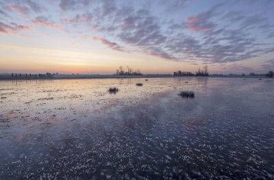 Scenic view of sea against sky at sunset