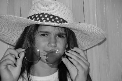 Close-up portrait of young woman wearing hat