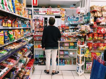 Rear view of man standing at market stall