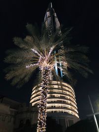 Low angle view of illuminated building against sky at night