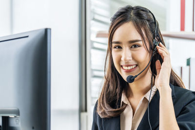 Portrait of smiling young woman using smart phone