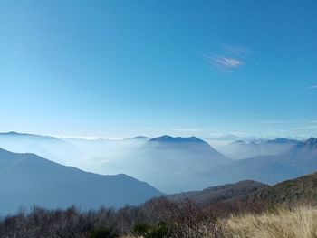 Scenic view of mountains against blue sky