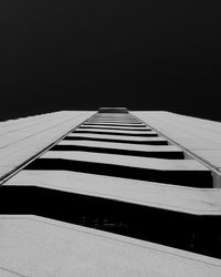 Tilt image of built structure against clear sky
