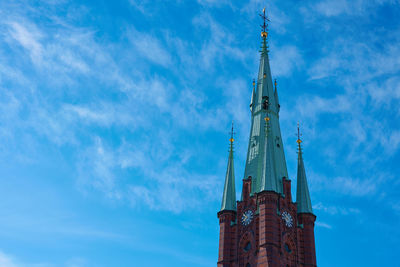Low angle view of building against cloudy sky