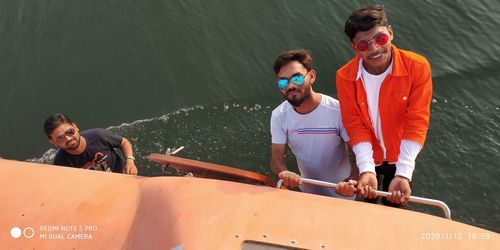 Friends on boat in sea