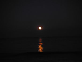 Scenic view of sea against clear sky at night