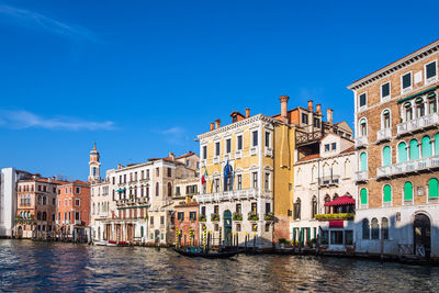 Canal passing through buildings in city