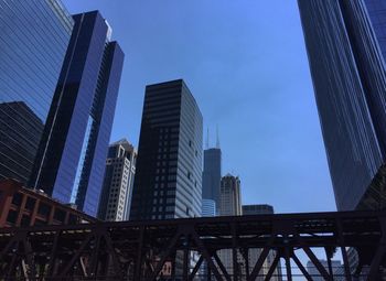 Low angle view of modern buildings against blue sky