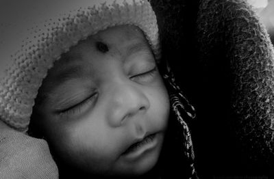 Close-up portrait of young woman with eyes closed