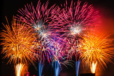 Low angle view of firework display at night