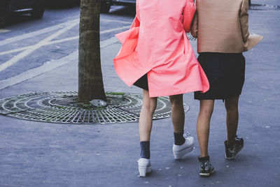 Low section of people walking on road