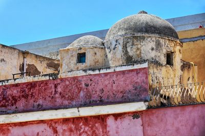 Low angle view of old building against blue sky