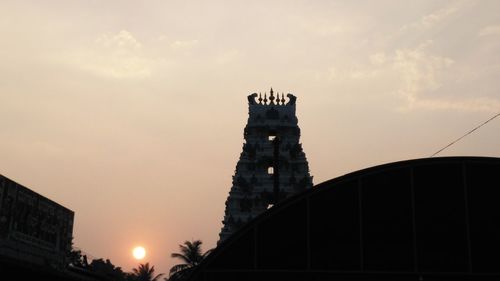 Low angle view of built structure against sky at sunset