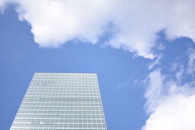 Low angle view of building against blue sky and clouds