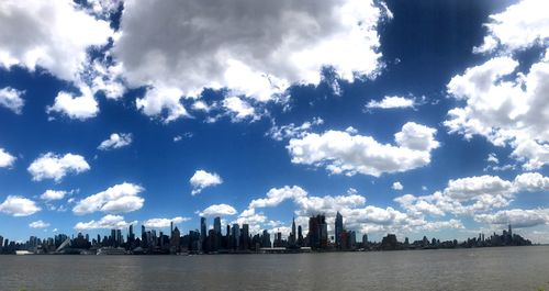 Panoramic view of city against cloudy sky