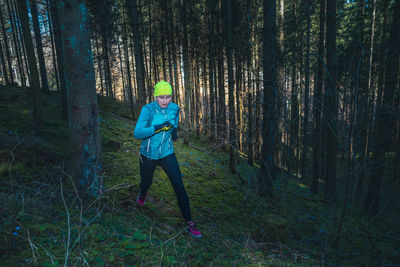 Full length of woman running in forest