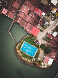 High angle view of swimming pool by river in city