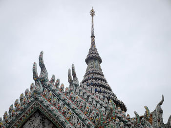 Low angle view of statue of temple against sky