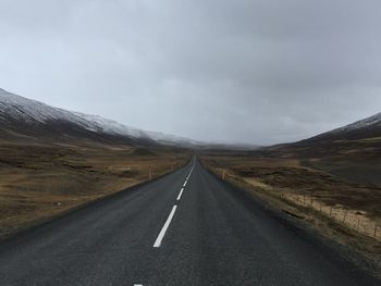 Road passing through landscape against sky